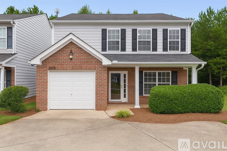 A house with a garage and a driveway in front.