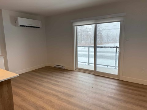 A room with a window and sliding glass door.