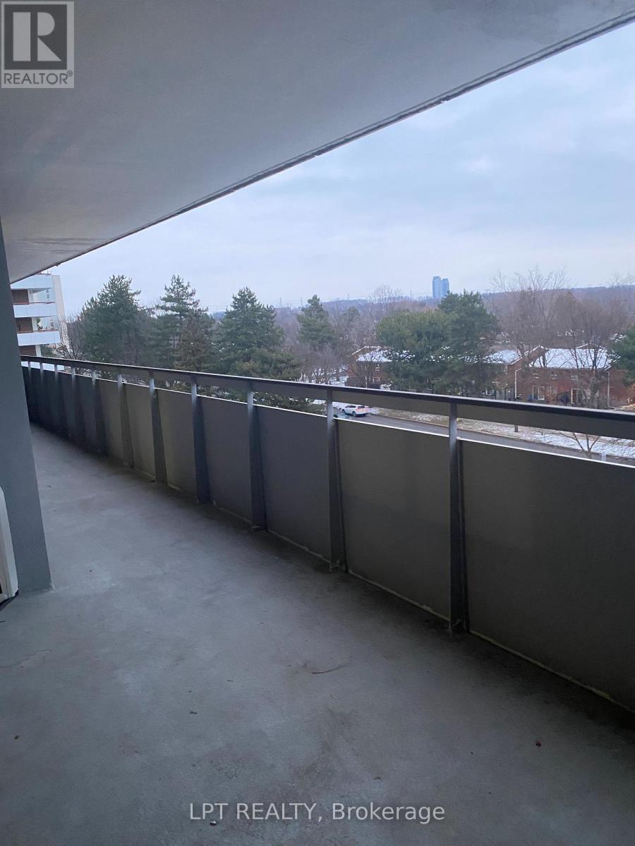 A balcony with a view of a city skyline.