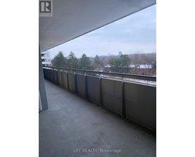 A balcony with a view of a city skyline.