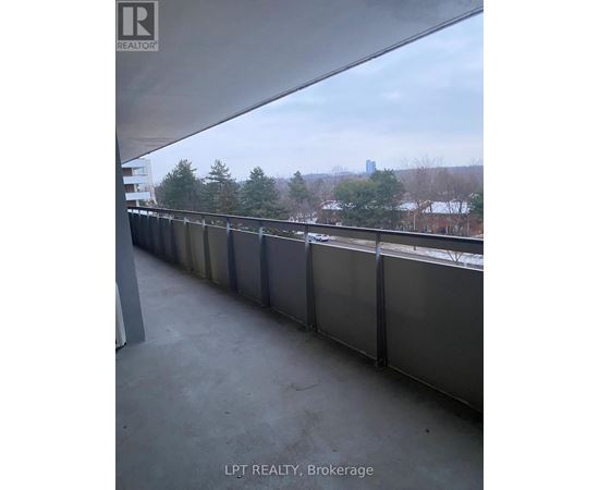 A balcony with a view of a city skyline.