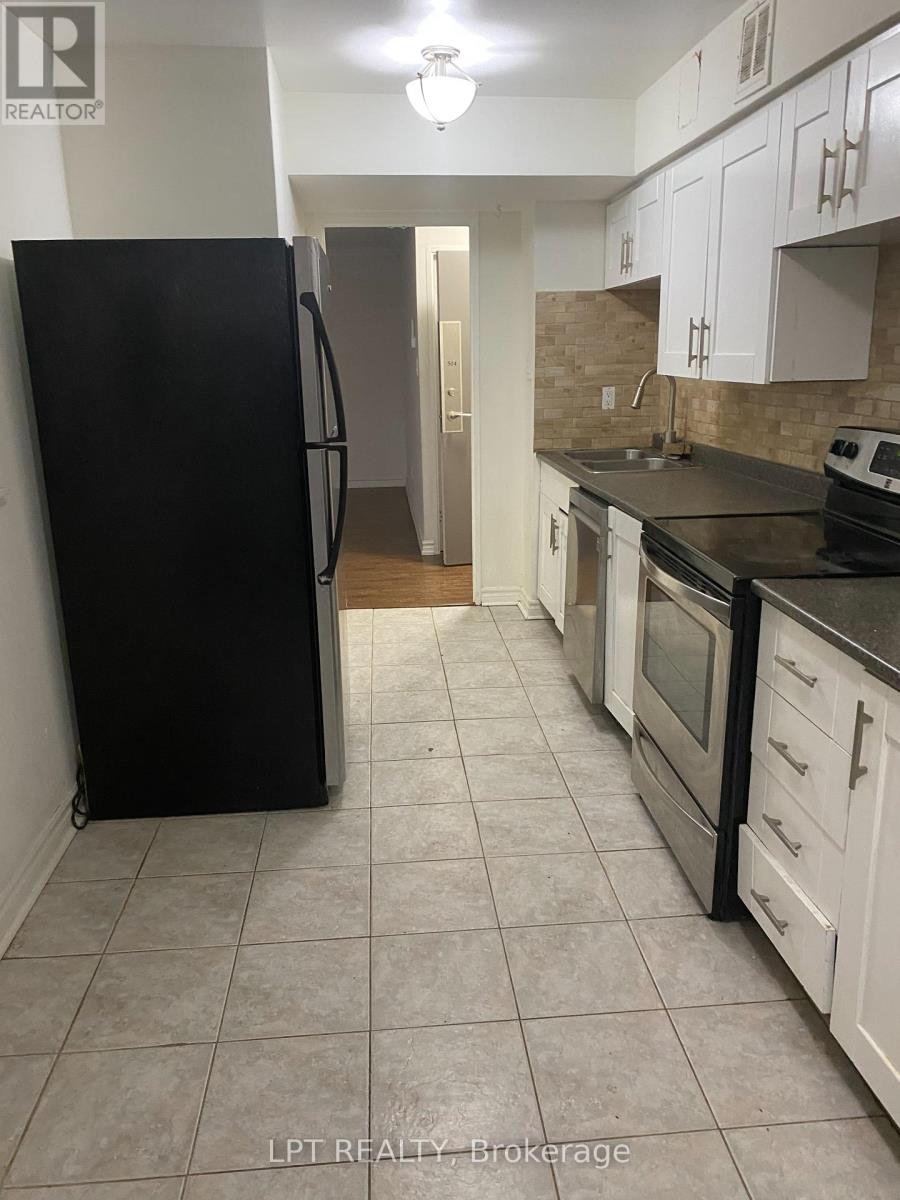 A kitchen with black appliances and white cabinets.