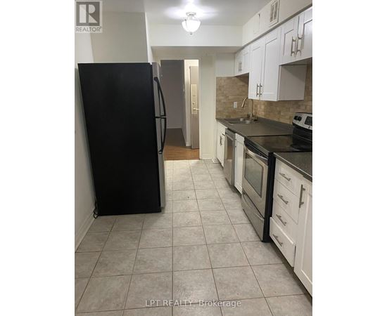 A kitchen with black appliances and white cabinets.
