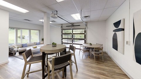 A dining room with a table and chairs.