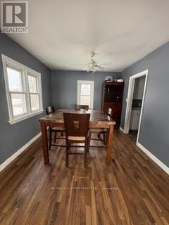 A dining room with a wooden table and chairs.