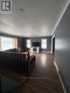 A living room with a couch and a television.