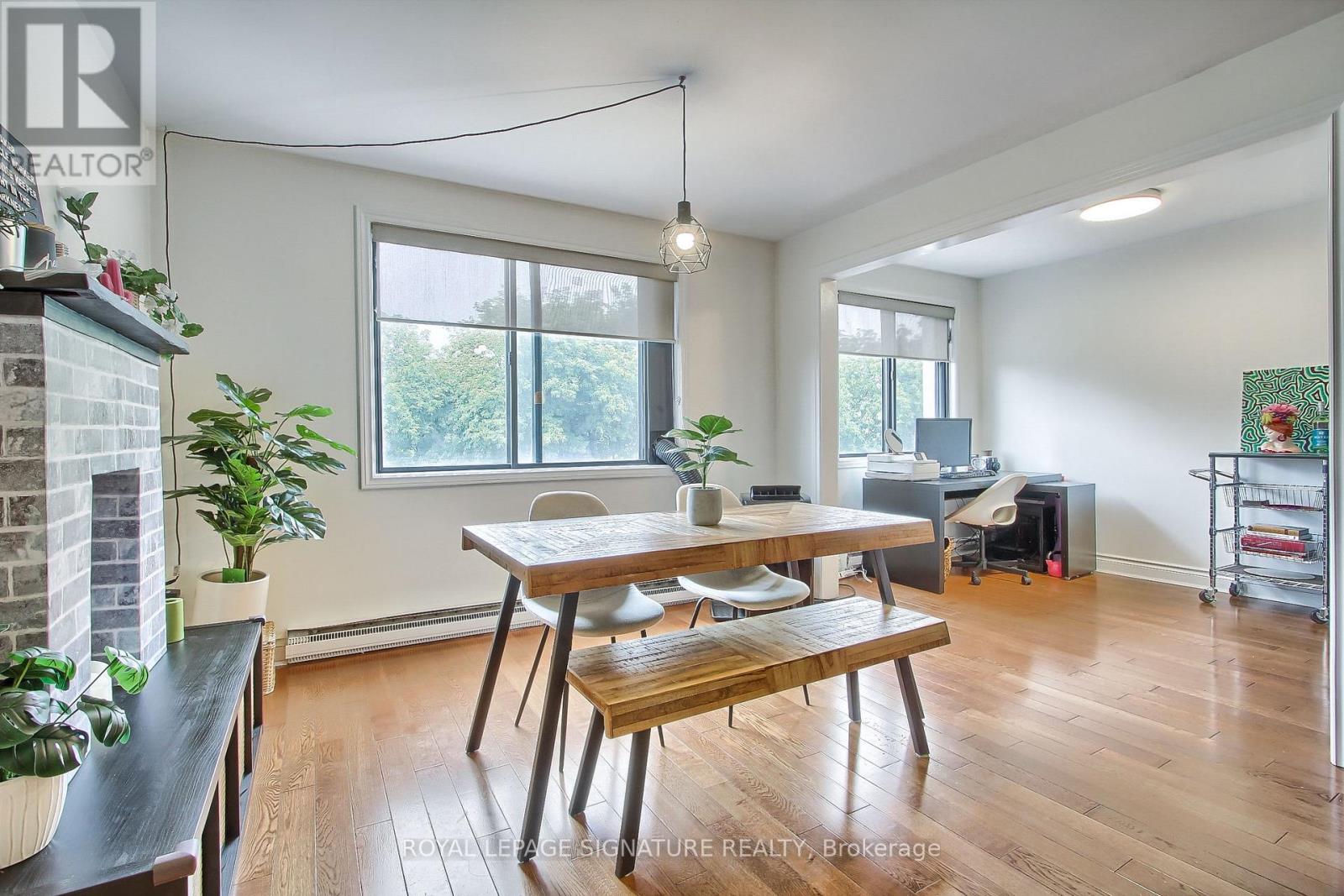 A dining room with a wooden table and chairs.