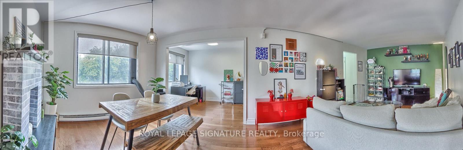 A living room with a couch, a table and a television.