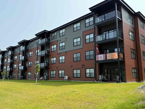 A large apartment building with balconies and multiple stories.