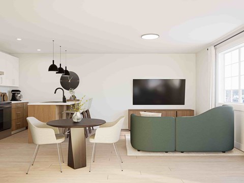 A modern living room with a dining table and chairs.