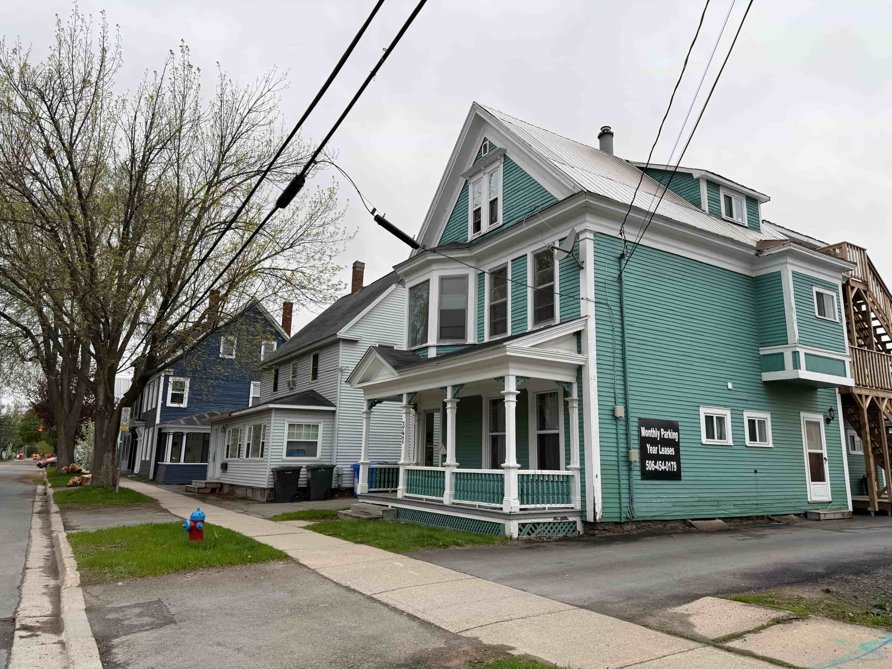 A blue house with a sign that says "Billy's Place" on it.