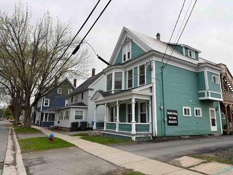 A blue house with a sign that says "Billy's Place" on it.