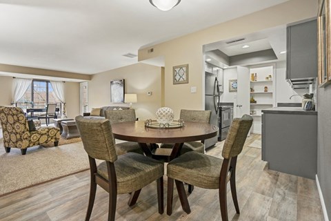 A dining room with a table set for four.