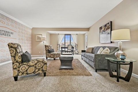 A living room with a sofa, armchair, and coffee table.