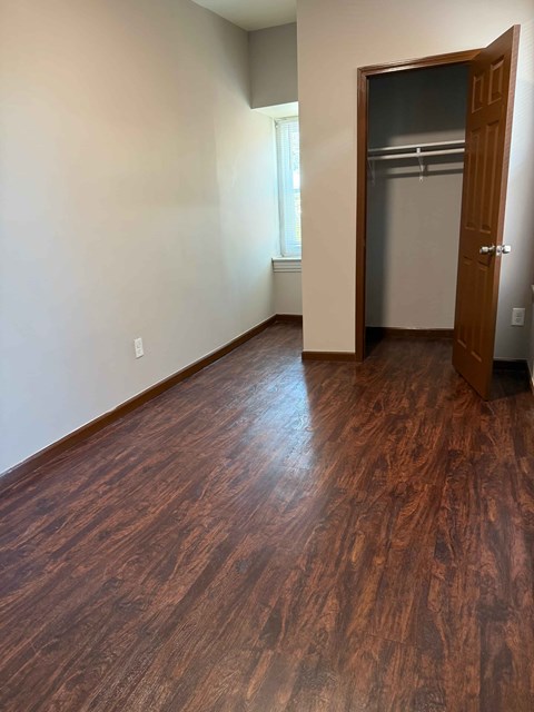A room with a wooden floor and a door.
