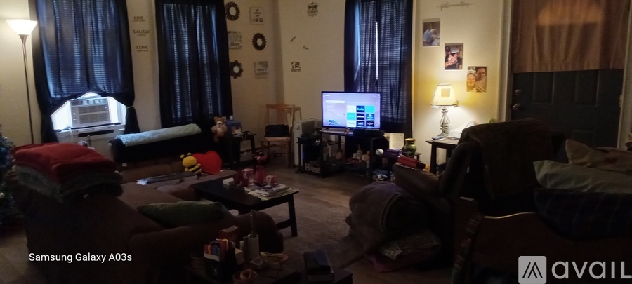 A living room with a television and a couch.