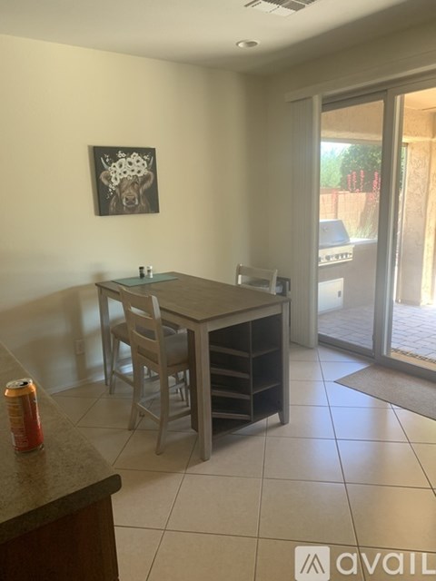 A dining area with a table and chairs.