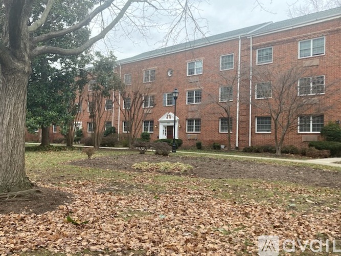 A brick building with a tree in front of it.