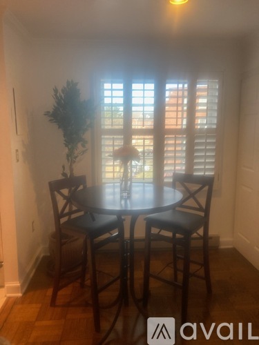 A dining room with a table and chairs.