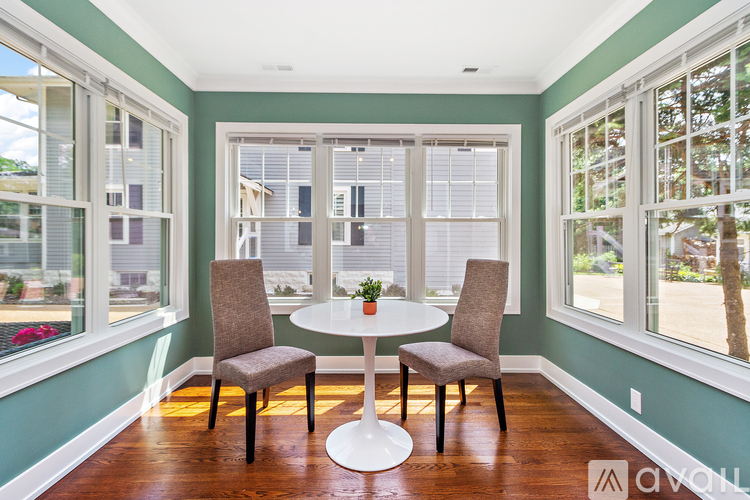 A dining room with a table and chairs.