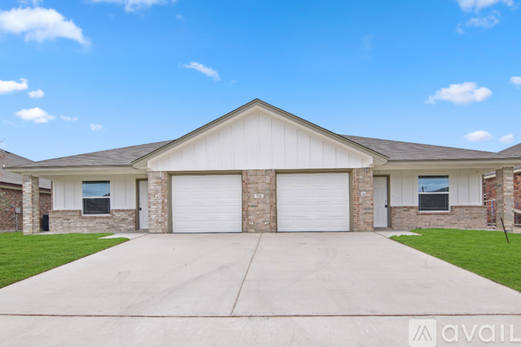 A two-story house with a garage is available for rent.