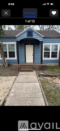 A blue house with a white door and windows.