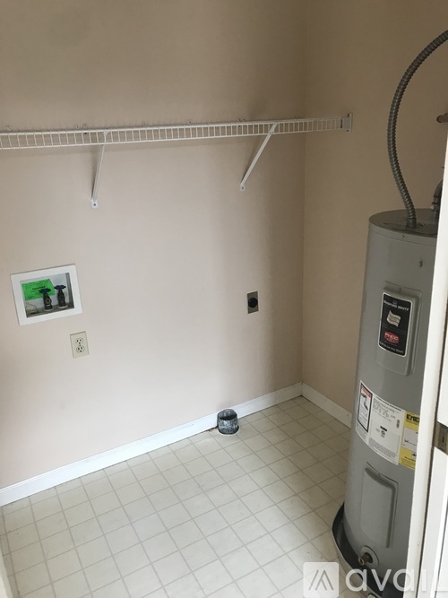 A room with a white tile floor and a picture on the wall.