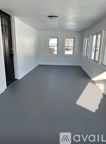 A room with a grey floor and white walls.