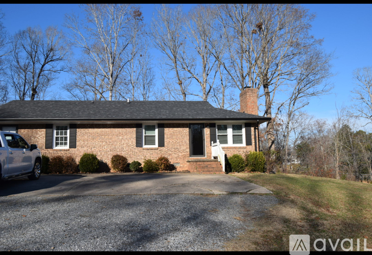 A house with a brick facade and a white door is for sale.