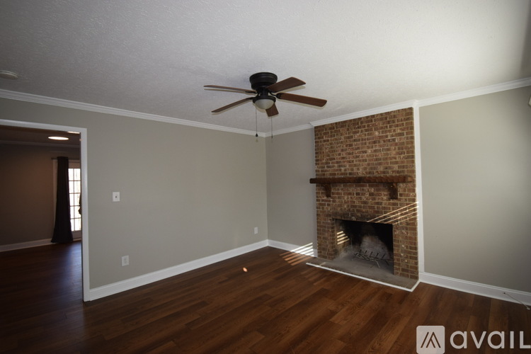 A room with a fireplace and a ceiling fan.