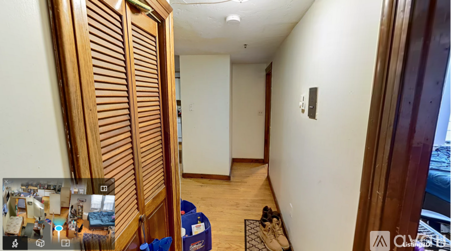 A room with a white wall and a wooden floor.
