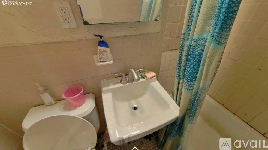 A bathroom with a toilet, sink, and shower curtain.