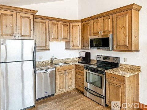 A kitchen with wooden cabinets and stainless steel appliances.