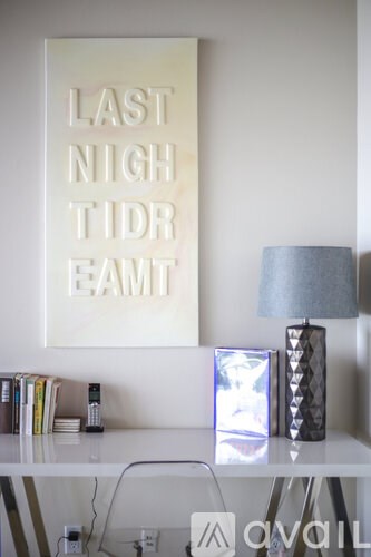 A white shelf with a lamp and a picture frame on it.