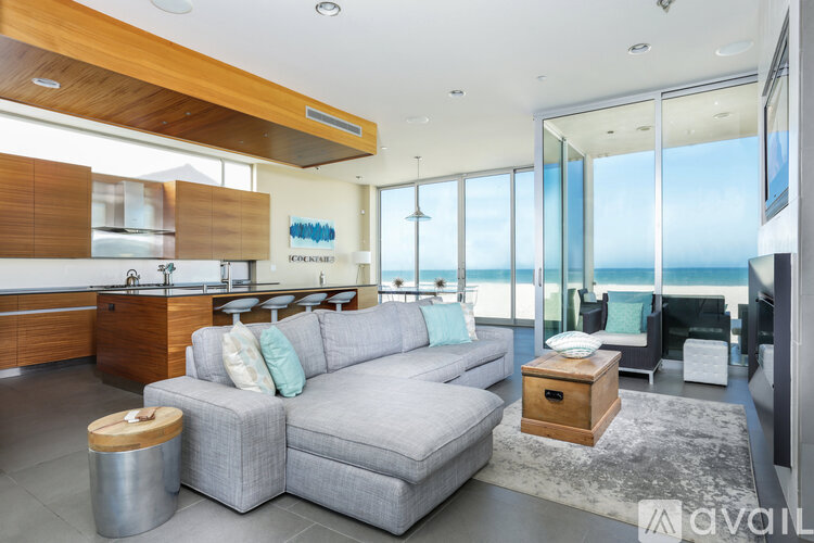 A modern living room with a grey sofa and a wooden coffee table.