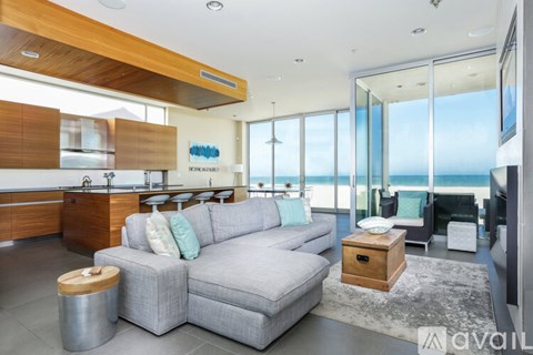 A modern living room with a grey sofa and a wooden coffee table.