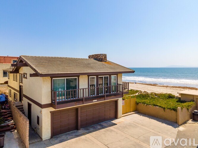 A house with a balcony overlooking the beach is for sale.