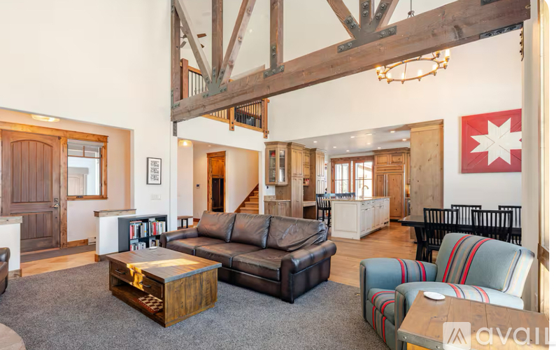 A living room with a large couch and a coffee table.