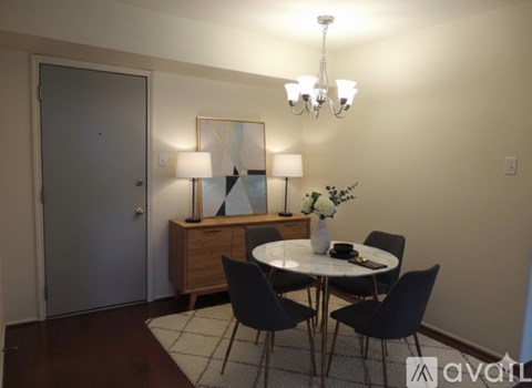 A room with a chandelier and a door.