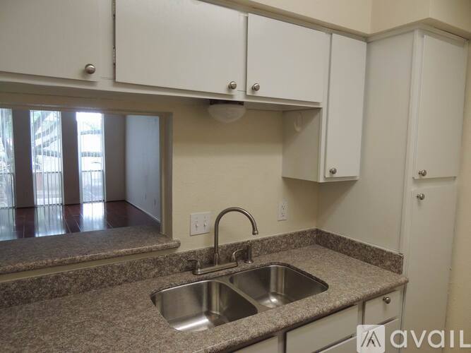 A kitchen with a sink and cabinets.