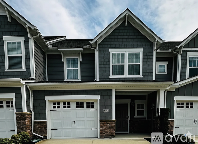 A two-story house with a garage on the first floor.