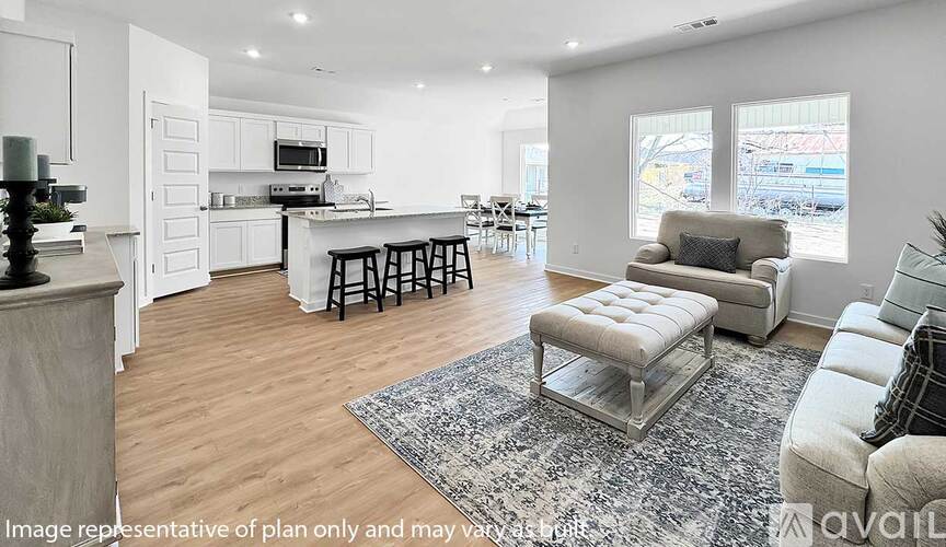 A modern kitchen with white cabinets and a dining area with a table and chairs.
