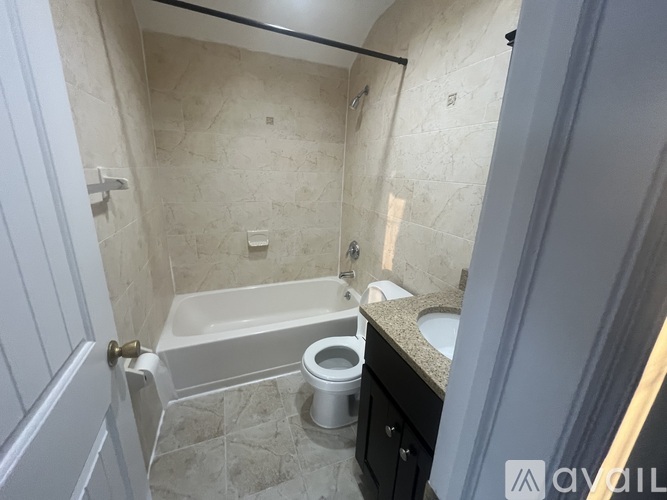 A bathroom with a bathtub, toilet, and sink.