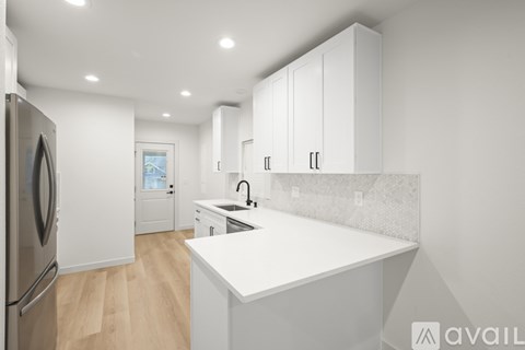A modern kitchen with white cabinets and a large island.