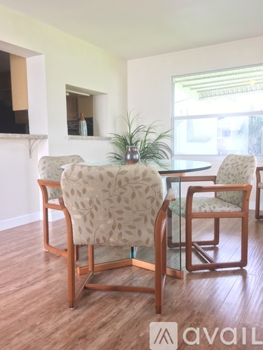 A dining room with a table and chairs.