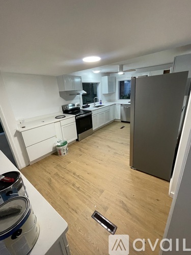 A kitchen with a refrigerator, stove, and oven.