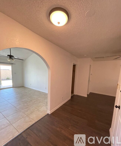 A room with a ceiling fan and a light fixture.