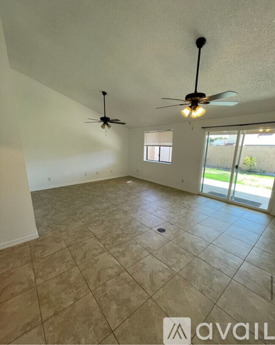 A room with tile flooring and two ceiling fans.
