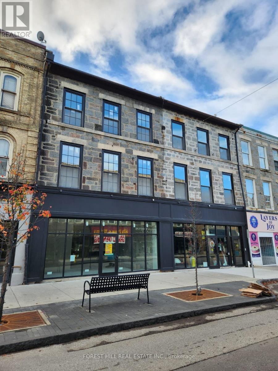 A street view of a building with a sign that says "Layers Joy".