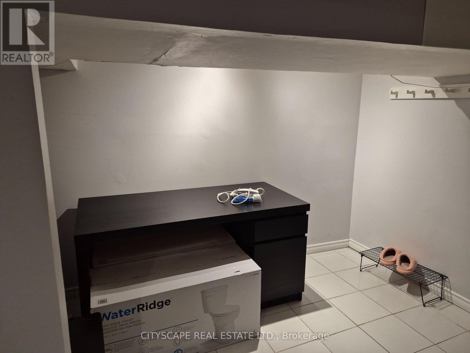 A room with a black desk and a box of WaterRidge.